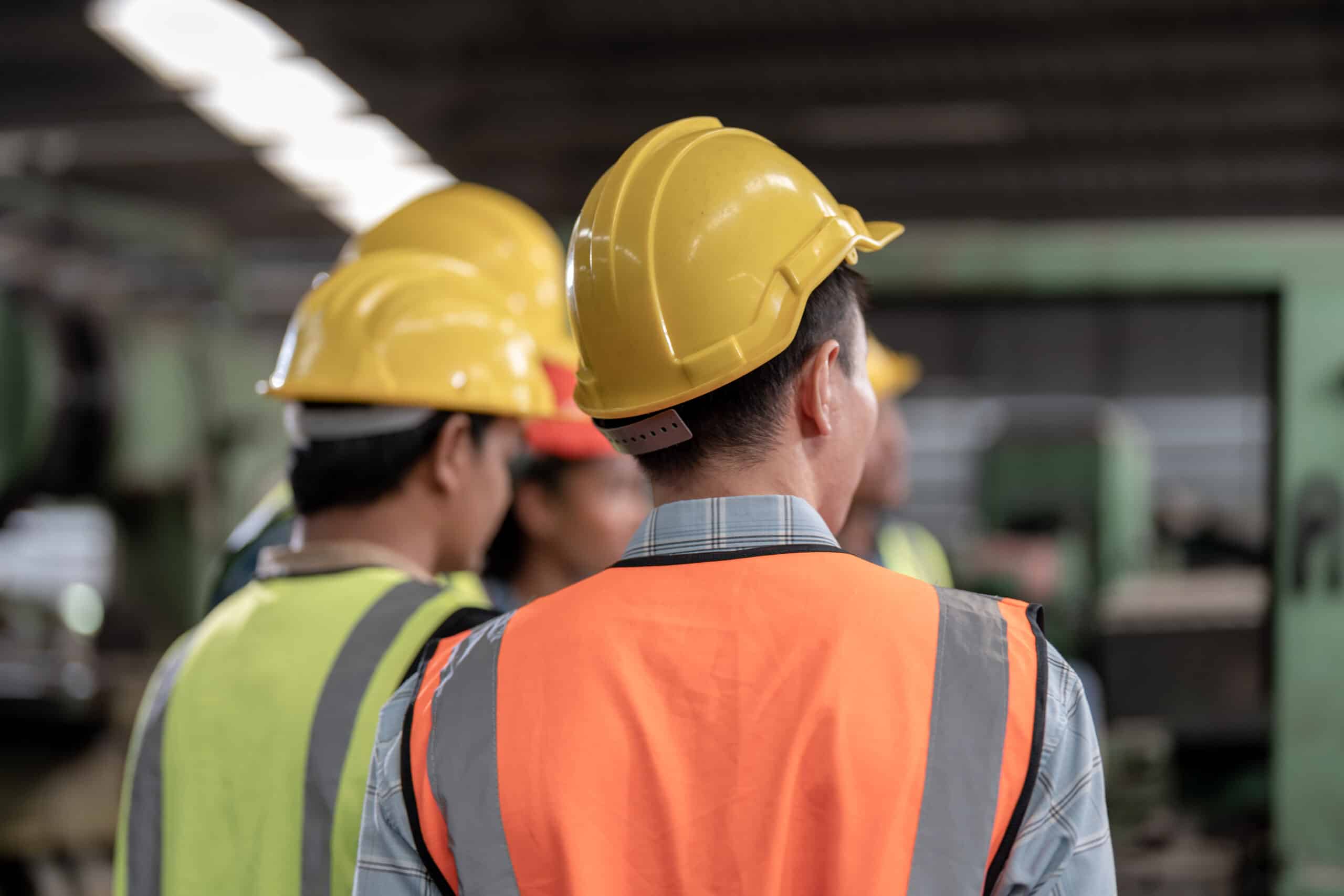 back of head engineers meeting. factory worker people walk and c