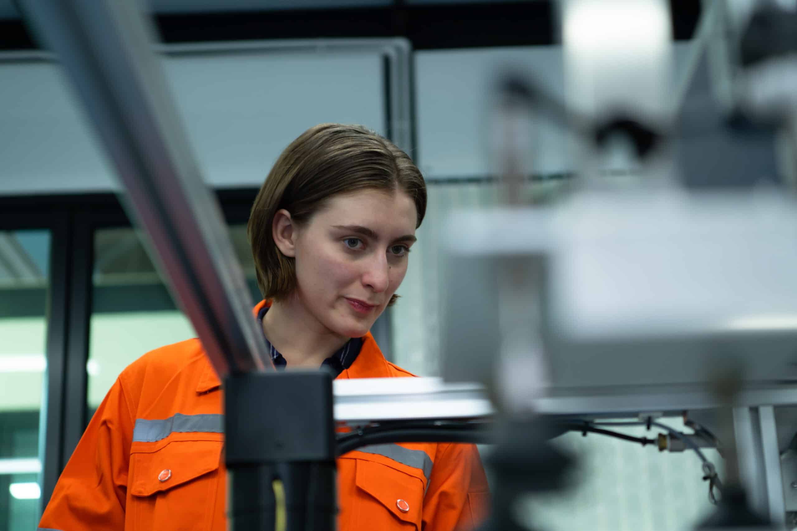 Young woman in an electronic parts factory Using a production li